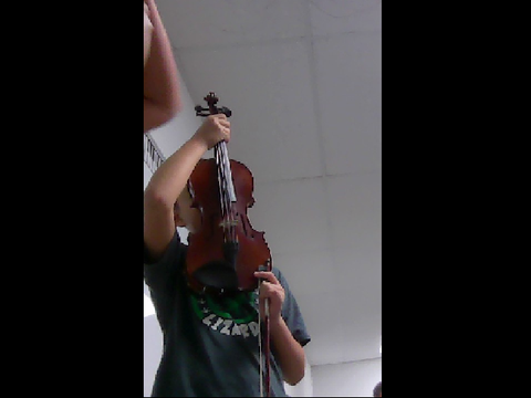 Johosone with a violin in his face